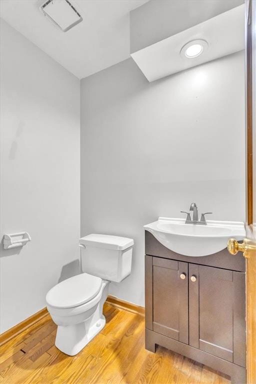 1600 NE 97th St, Kansas City, MO 64155 - half bathroom with vanity, toilet, wood finished floors, and baseboards