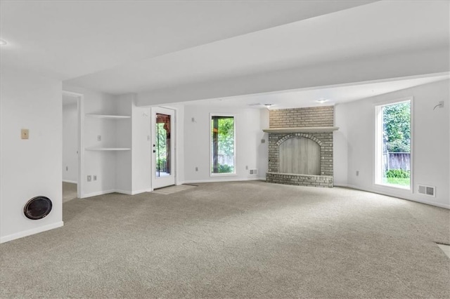 1600 NE 97th St, Kansas City, MO 64155 - unfurnished living room with carpet floors, baseboards, plenty of natural light, and a brick fireplace