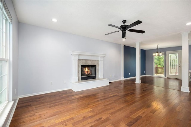 417 N Locust St, Gardner, KS 66030 - unfurnished living room with a glass covered fireplace, wood finished floors, recessed lighting, a ceiling fan, and decorative columns