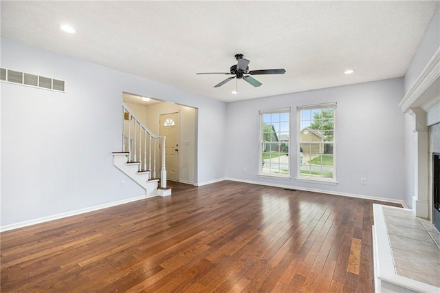 417 N Locust St, Gardner, KS 66030 - unfurnished living room featuring a fireplace, dark wood-type flooring, a ceiling fan, stairs, and recessed lighting