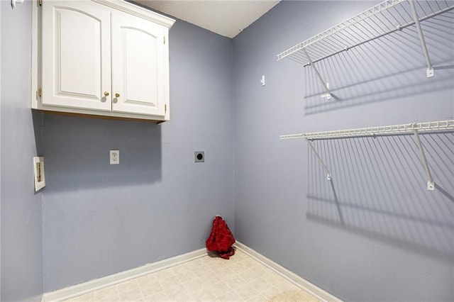 417 N Locust St, Gardner, KS 66030 - washroom with electric dryer hookup, cabinet space, and tile patterned floors