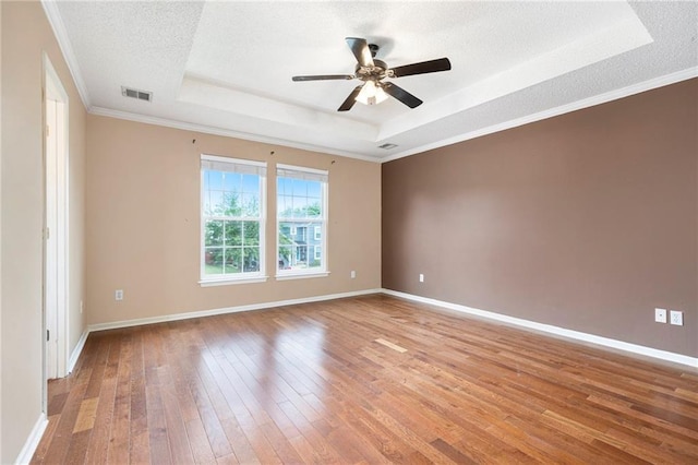 417 N Locust St, Gardner, KS 66030 - empty room with a raised ceiling, hardwood / wood-style floors, ceiling fan, a textured ceiling, and crown molding