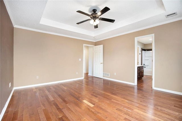 417 N Locust St, Gardner, KS 66030 - unfurnished bedroom featuring a raised ceiling, wood finished floors, crown molding, and a ceiling fan