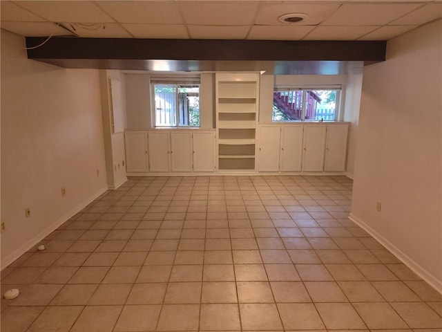 417 N Locust St, Gardner, KS 66030 - basement with light tile patterned flooring, a paneled ceiling, and plenty of natural light