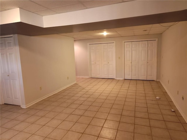 417 N Locust St, Gardner, KS 66030 - unfurnished bedroom featuring a paneled ceiling, two closets, and light tile patterned flooring