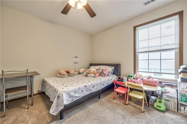 bedroom featuring multiple windows, carpet flooring, and ceiling fan