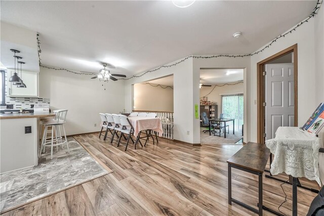 dining area featuring ceiling fan and light wood finished floors
