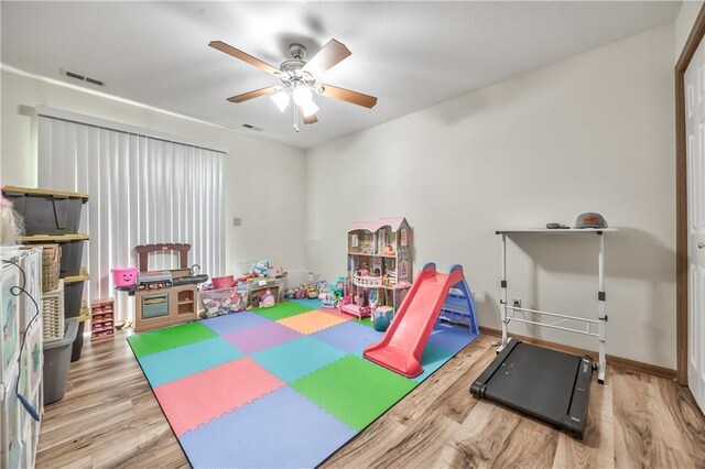 game room featuring wood finished floors, ceiling fan, and baseboards