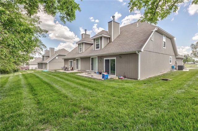 back of property featuring a patio area, a chimney, central air condition unit, and a lawn