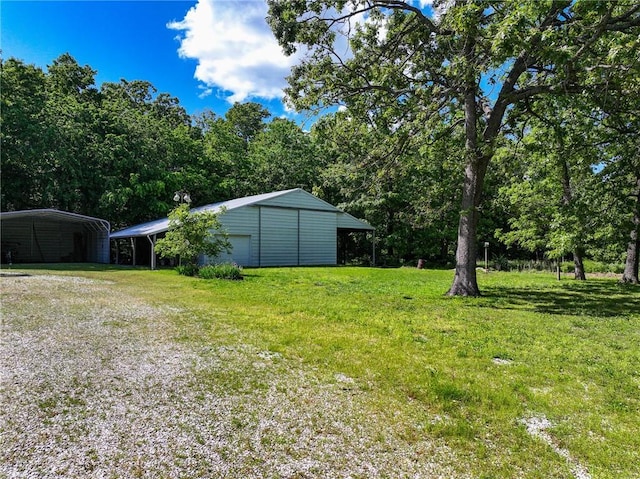 20435 Rb Hwy, Flemington, MO 65650 - view of grassy yard with an outbuilding, a carport, a detached garage, and driveway