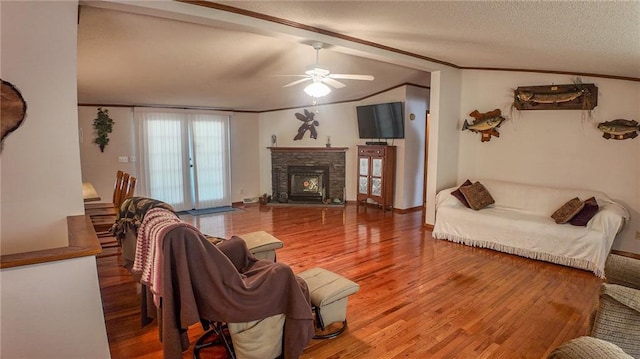 20435 Rb Hwy, Flemington, MO 65650 - living room featuring wood finished floors, a ceiling fan, ornamental molding, lofted ceiling, and a stone fireplace