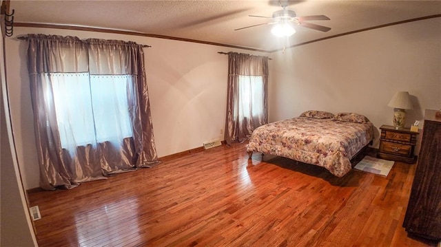20435 Rb Hwy, Flemington, MO 65650 - bedroom featuring crown molding, wood finished floors, a ceiling fan, and a textured ceiling