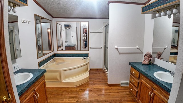 20435 Rb Hwy, Flemington, MO 65650 - bathroom with a shower stall, wood finished floors, a garden tub, a textured ceiling, and two vanities