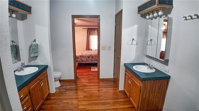 20435 Rb Hwy, Flemington, MO 65650 - full bath with wood finished floors, toilet, two vanities, and ensuite bathroom