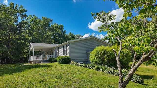 20435 Rb Hwy, Flemington, MO 65650 - view of side of home featuring covered porch, a yard, and a ceiling fan