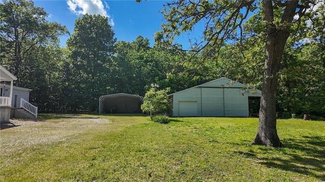 20435 Rb Hwy, Flemington, MO 65650 - view of grassy yard featuring driveway, a detached carport, an outdoor structure, and a detached garage