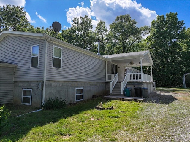 20435 Rb Hwy, Flemington, MO 65650 - view of property exterior with a yard, ceiling fan, and covered porch