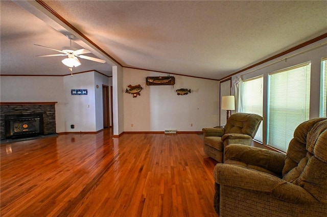 20435 Rb Hwy, Flemington, MO 65650 - living area with crown molding, wood finished floors, ceiling fan, lofted ceiling, and a textured ceiling