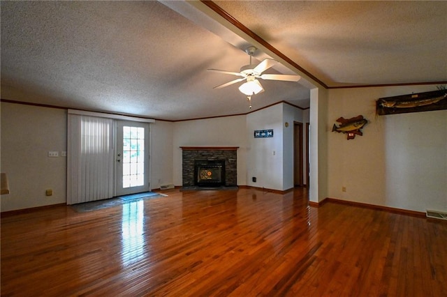 20435 Rb Hwy, Flemington, MO 65650 - unfurnished living room featuring a textured ceiling, wood finished floors, a ceiling fan, crown molding, and a stone fireplace