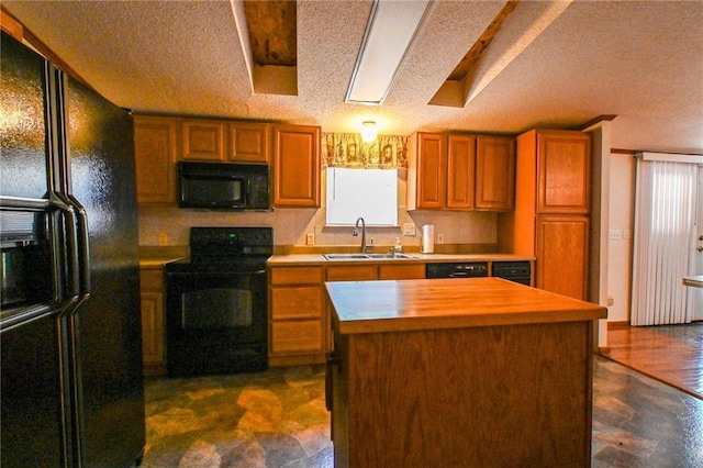 20435 Rb Hwy, Flemington, MO 65650 - kitchen featuring black appliances, a sink, healthy amount of natural light, brown cabinetry, and a textured ceiling