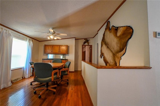 20435 Rb Hwy, Flemington, MO 65650 - dining room featuring dark wood finished floors, ceiling fan, crown molding, a desk, and a textured ceiling