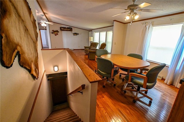 20435 Rb Hwy, Flemington, MO 65650 - dining area with ceiling fan, wood-type flooring, lofted ceiling, crown molding, and a textured ceiling