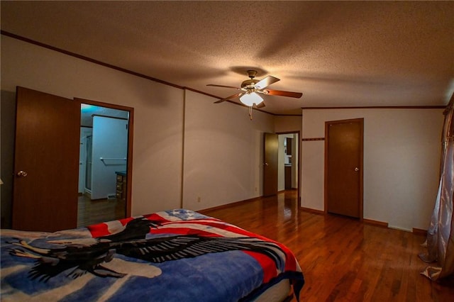 20435 Rb Hwy, Flemington, MO 65650 - bedroom featuring wood finished floors, ornamental molding, a textured ceiling, a ceiling fan, and baseboards