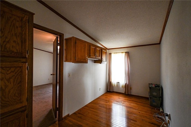 20435 Rb Hwy, Flemington, MO 65650 - empty room with ornamental molding, a textured ceiling, dark wood-style flooring, and lofted ceiling
