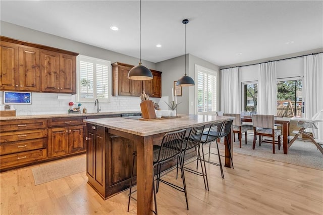 301 Sunrise Dr, Louisburg, KS 66053 - kitchen featuring healthy amount of natural light, a sink, brown cabinetry, and recessed lighting