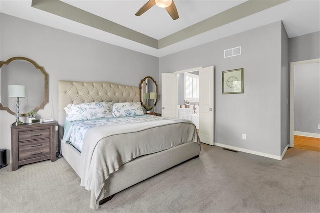 301 Sunrise Dr, Louisburg, KS 66053 - carpeted bedroom featuring baseboards, a raised ceiling, ceiling fan, and ensuite bath