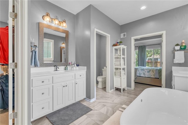 301 Sunrise Dr, Louisburg, KS 66053 - bathroom with ensuite bath, a freestanding bath, vanity, toilet, and baseboards