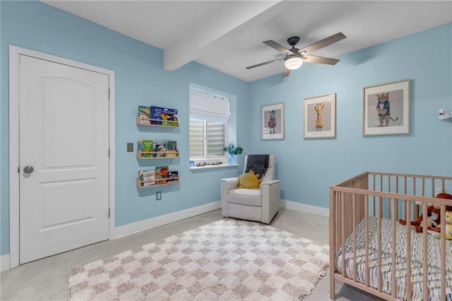 301 Sunrise Dr, Louisburg, KS 66053 - carpeted bedroom with a nursery area, beam ceiling, baseboards, and ceiling fan
