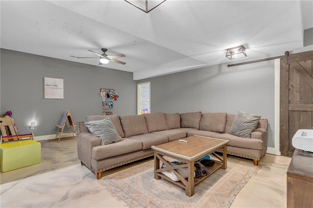 301 Sunrise Dr, Louisburg, KS 66053 - living area with a barn door, a ceiling fan, baseboards, and a textured ceiling
