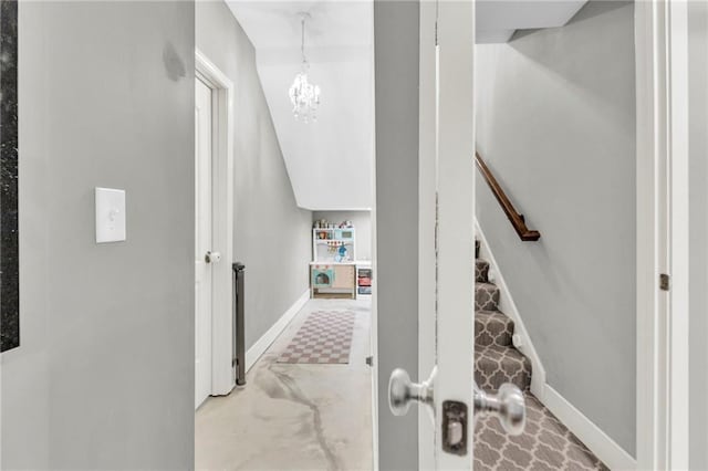 301 Sunrise Dr, Louisburg, KS 66053 - stairway featuring baseboards and a chandelier