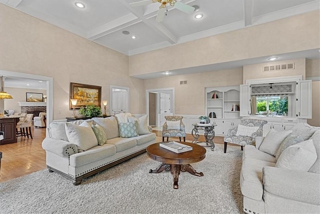12613 Sherwood St, Leawood, KS 66209 - living area featuring coffered ceiling, ceiling fan, light wood finished floors, beam ceiling, and a high ceiling