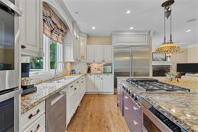 12613 Sherwood St, Leawood, KS 66209 - kitchen with a sink, light wood-type flooring, white cabinets, light stone counters, and recessed lighting
