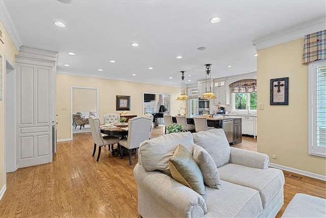 12613 Sherwood St, Leawood, KS 66209 - living area featuring crown molding, recessed lighting, baseboards, and light wood-style flooring