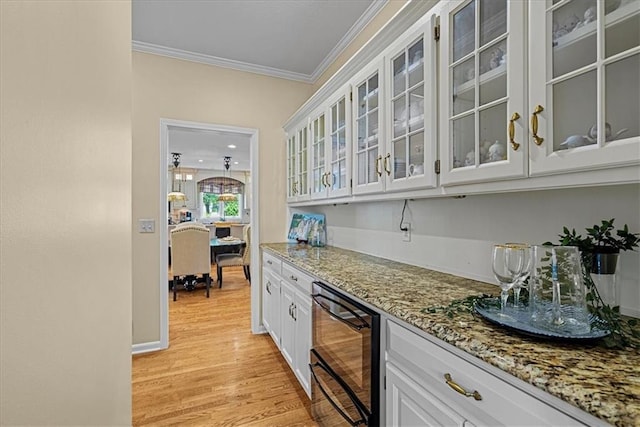 12613 Sherwood St, Leawood, KS 66209 - indoor dry bar featuring ornamental molding, light wood-type flooring, and beverage cooler