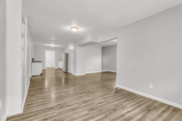 315 S Crane St S, Independence, MO 64050 - unfurnished living room with baseboards and wood finished floors