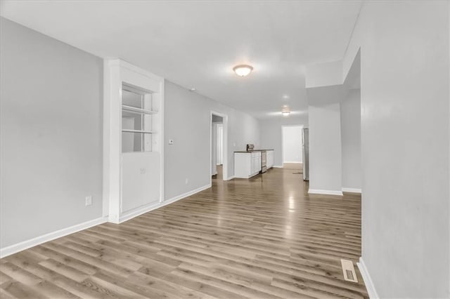 315 S Crane St S, Independence, MO 64050 - spare room featuring wood finished floors and baseboards
