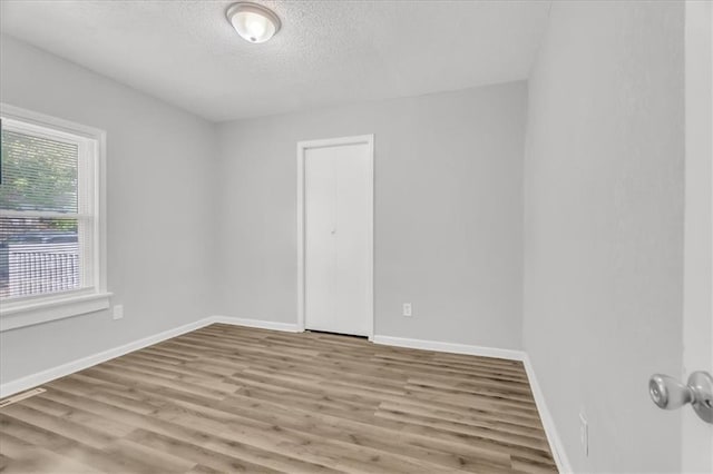 315 S Crane St S, Independence, MO 64050 - unfurnished room with wood finished floors, a textured ceiling, and baseboards