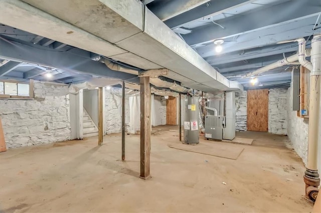 315 S Crane St S, Independence, MO 64050 - below grade area with electric water heater, stairway, and heating unit