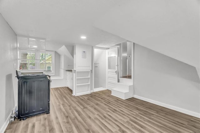 315 S Crane St S, Independence, MO 64050 - unfurnished living room featuring wood finished floors, baseboards, and recessed lighting