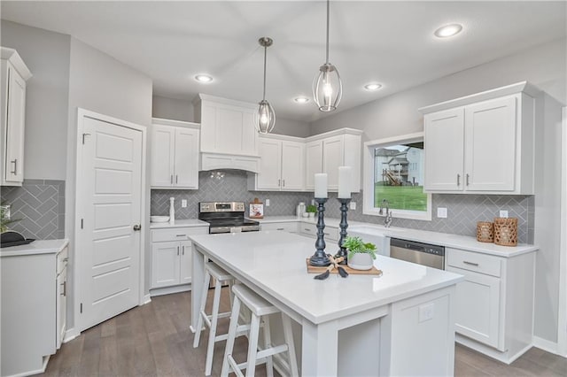 kitchen with stainless steel appliances, dark wood-type flooring, white cabinetry, backsplash, and recessed lighting
