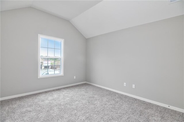 additional living space featuring lofted ceiling, carpet floors, and baseboards