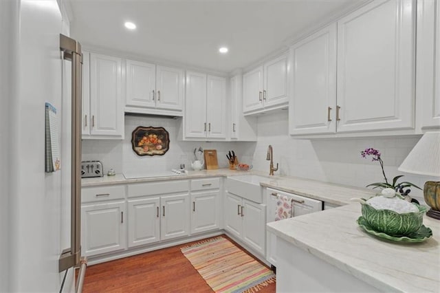 kitchen featuring white appliances, white cabinetry, and recessed lighting