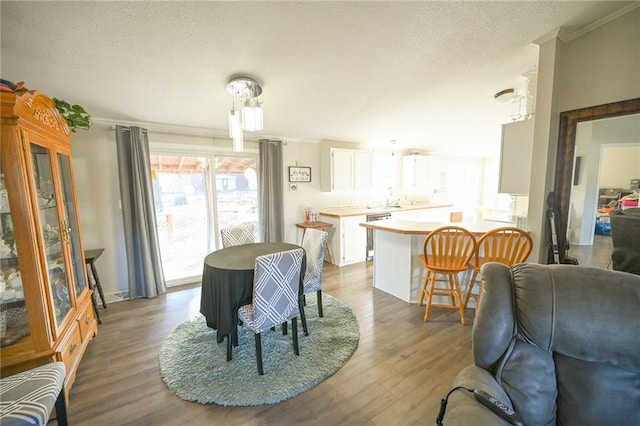 20662 Rb Hwy, Flemington, MO 65650 - dining room with crown molding, wood finished floors, and a textured ceiling