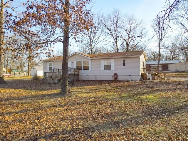 20662 Rb Hwy, Flemington, MO 65650 - rear view of property featuring a wooden deck, an outdoor structure, and a shed