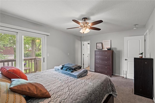 carpeted bedroom with access to exterior, a ceiling fan, and baseboards