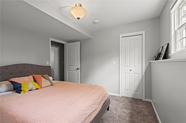 bedroom with carpet flooring, a closet, and baseboards